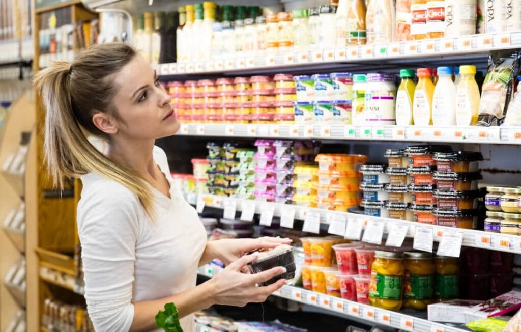woman at grocery story - do you worry about money when shopping?